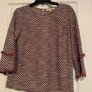Maroon and white patterned shirt.
